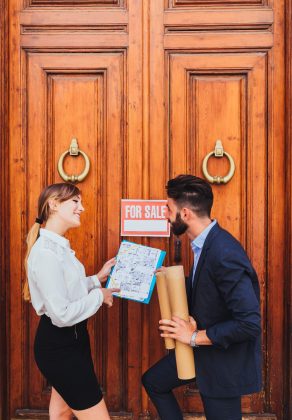 happy-real-estate-agent-showing-plans